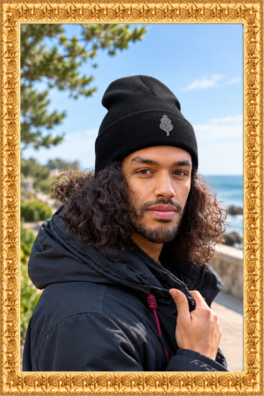 Black cuffed beanie in a fresh outdoor setting inside the gold frame